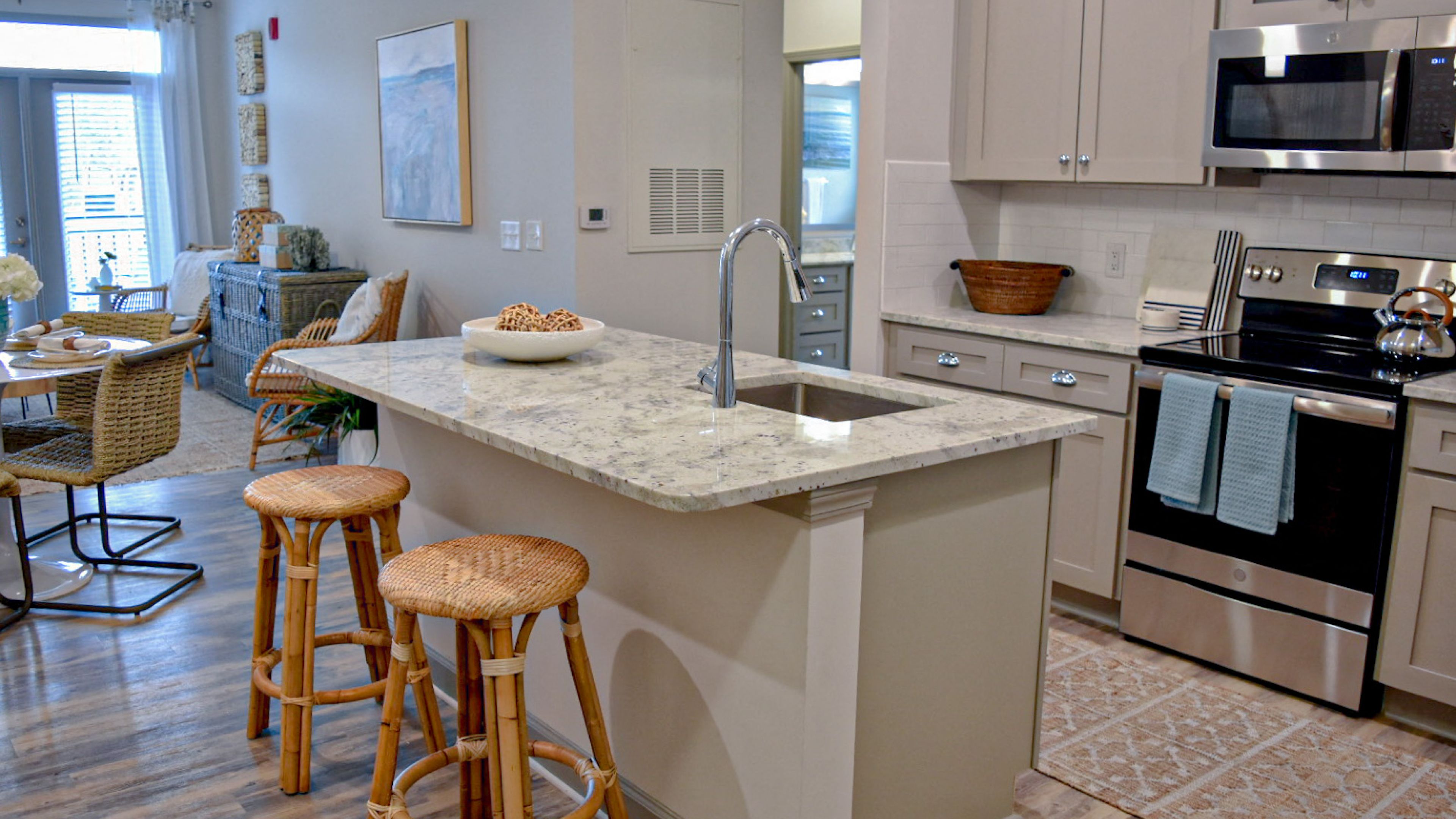 Hawthorne at Smith Creek apartment kitchen with quartz countertops, stainless steel appliances, and ample cabinet storage